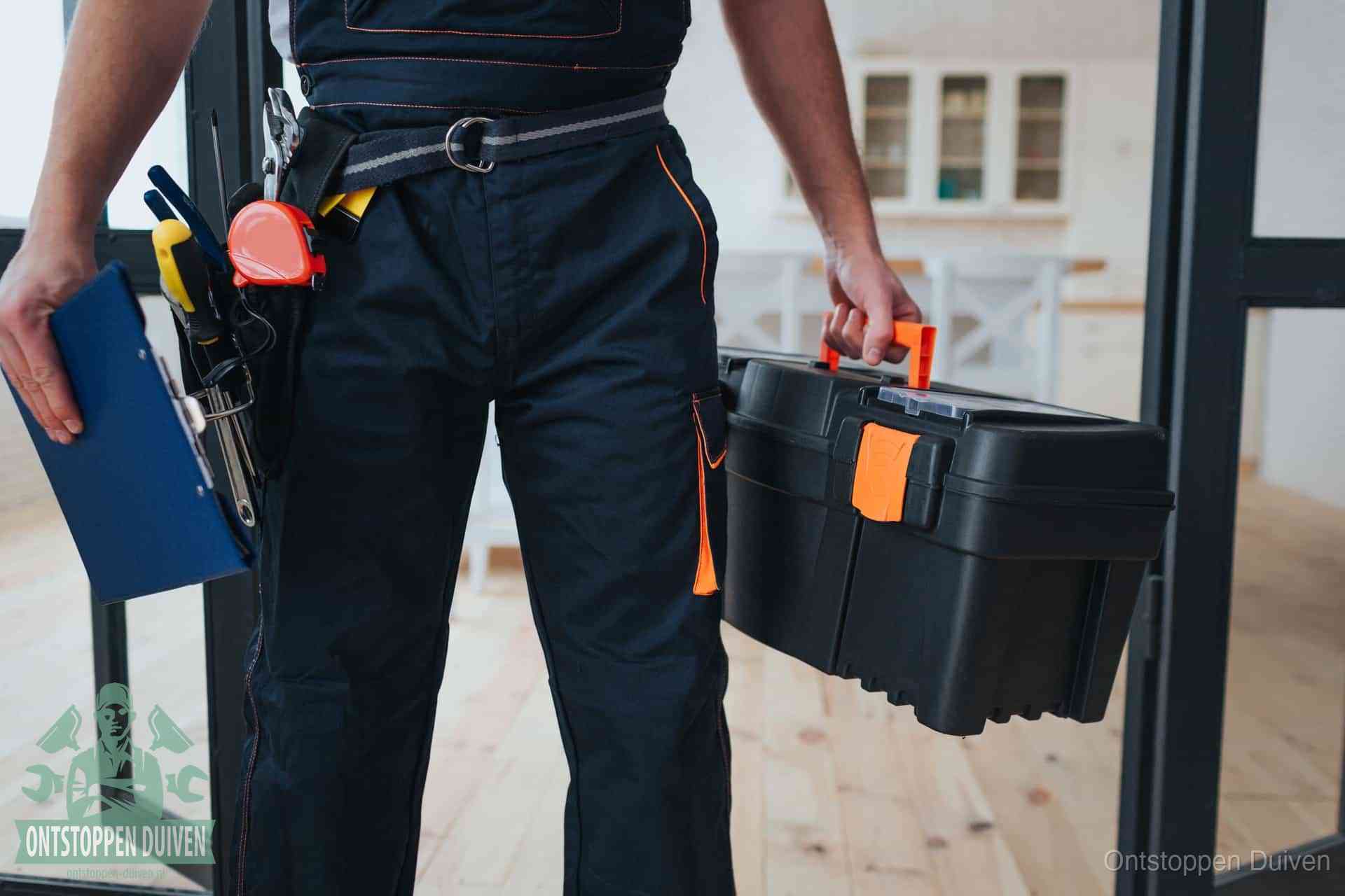 Een monteur met gereedschapsriem en klembord, klaar om een transparante prijs voor het afvoer ontstoppen in Duiven te geven
